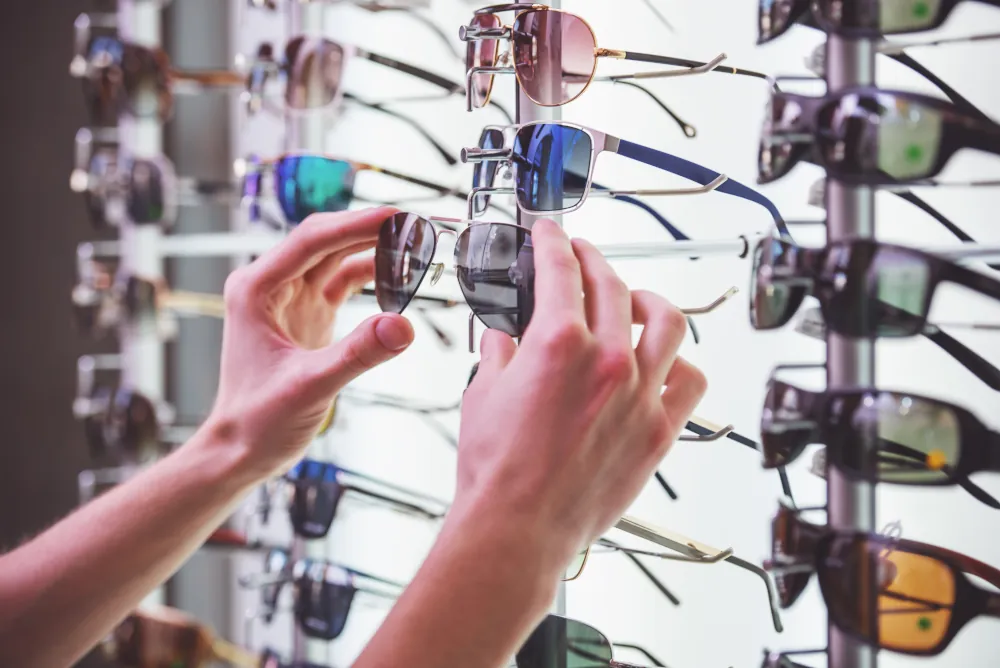 Designer eyewear frames arranged on display shelves